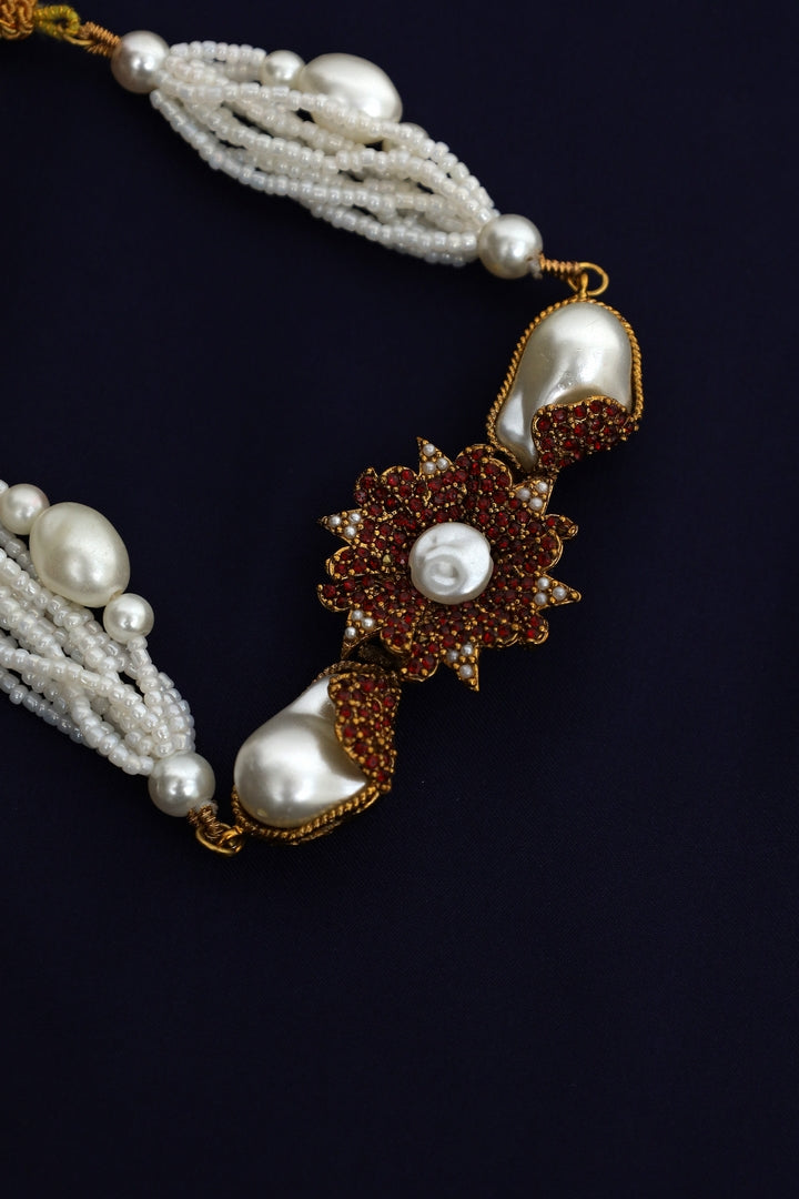 Pearl necklace with a decorative clasp.