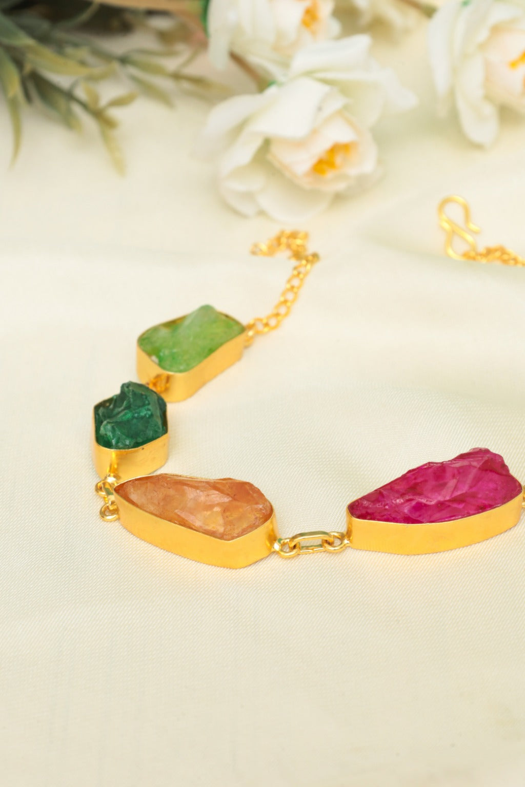 Bracelet with colorful stone beads on a light background